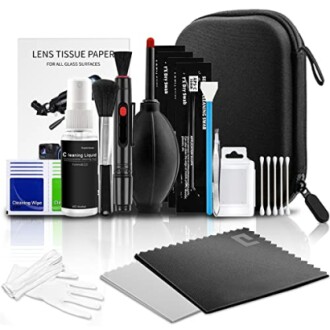 Camera lens cleaning kit with various tools and accessories.