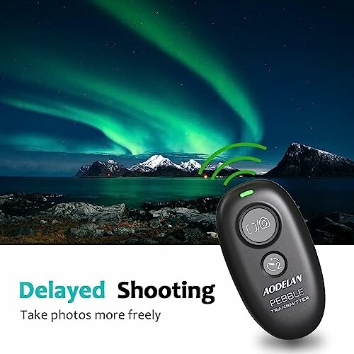 Remote control device with northern lights in the background.