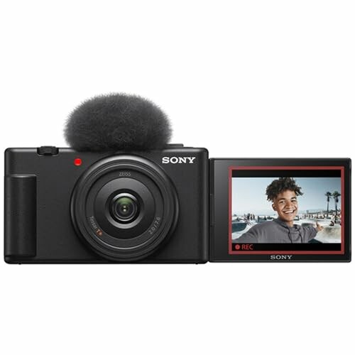 Sony vlog camera with flip-out screen displaying a smiling person.